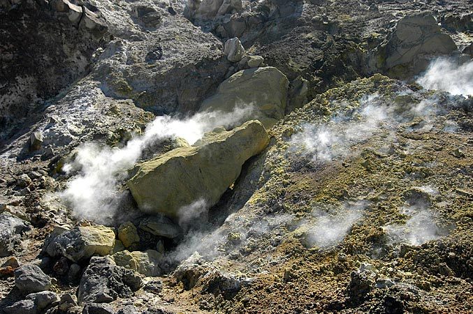 In the crater, smoke just seeps up through the rocks.