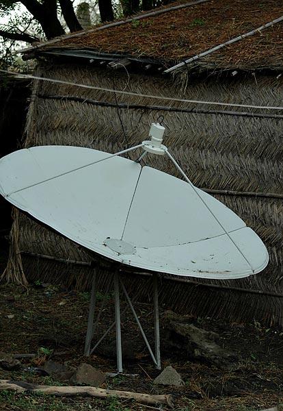 Mud huts and thatched huts...  with generators, tvs and satellite dishes.