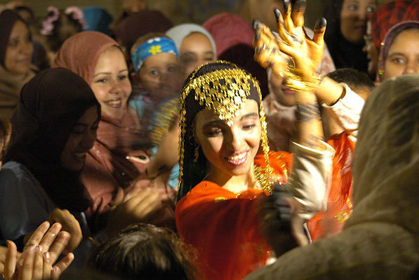 Bride dancing.  It wasn't actually the wedding, but a bridal party the night before the wedding.  The henna decorations are traditional, and the gold she's wearing is a traditional dowry gift.