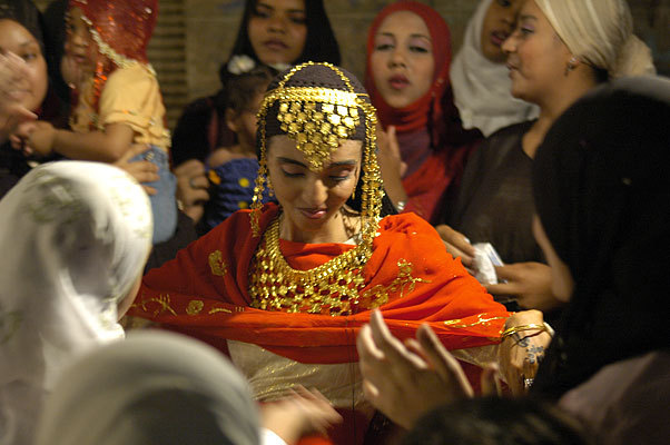 Bride dancing.  It wasn't actually the wedding, but a bridal party the night before the wedding.  The henna decorations are traditional, and the gold she's wearing is a traditional dowry gift.