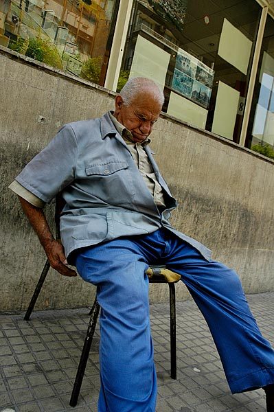 Newspaper vendor asleep near the American University.