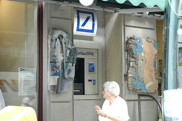 I found this overly symbolic - A 'money' machine framed by two pieces of the broken down wall.  Capitalism won!