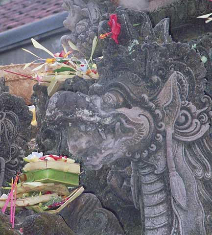 Another demon decorated with flowers and sacrifices.