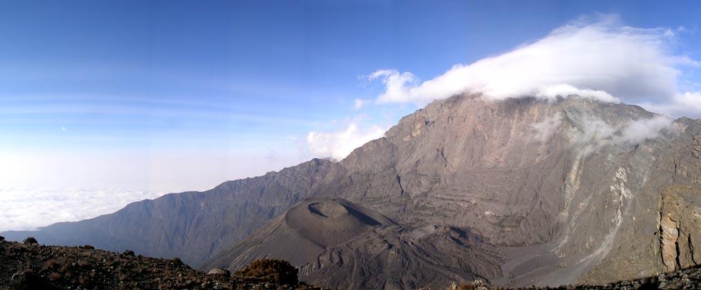 This massive crates is leftover from a volcanic eruption.  Mt. Meru (15,000'), with it's peak hidden in a cloud lies on the other side of the crater.